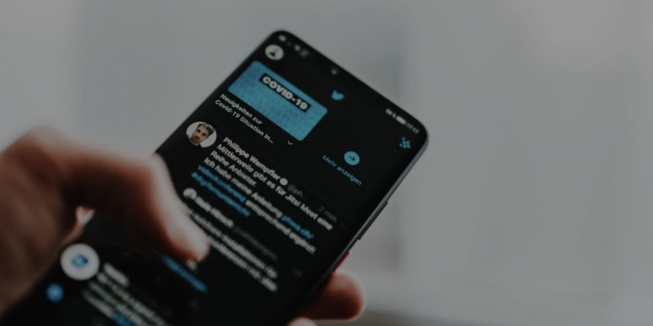 Image of phone on a social media platform with information of covid-19 displayed